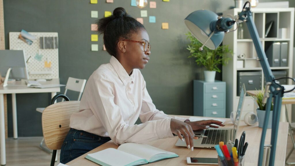 Woman looking mentally tired while working at a laptop